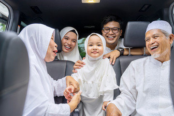 Wall Mural - Cheerful family enjoying their journey in a car