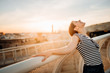 © eldarnurkovic - Cheerful happy spanish woman enjoying sunset from a cityscape viewpoint.Tourist having amazing time in Seville,Andalucia,Spain. Opportunities and experience in Andalucia.Enjoying sunshine and panorama