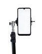 Smartphone mounted on a black tripod in a vertical position on a light isolated background tilted to the right.