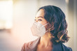 © brain2hands - Close-up of a pretty Asian girl with wavy hair. She wore Hygienic mask to protect themselves from the spread of the virus covid-19 and protected from dust pollution, which is spread in the air.