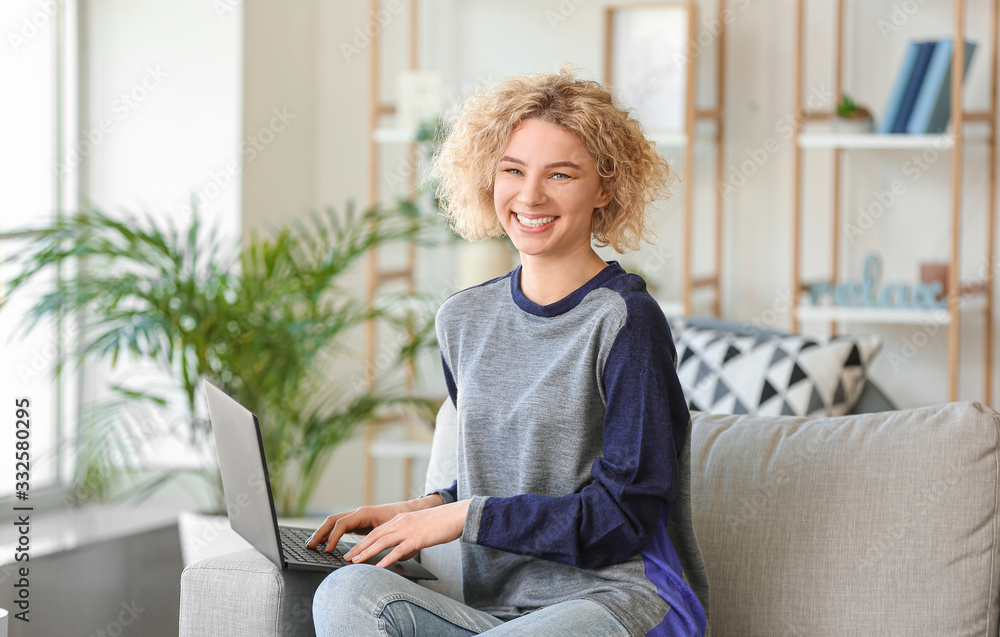 Beautiful young woman with laptop at home
