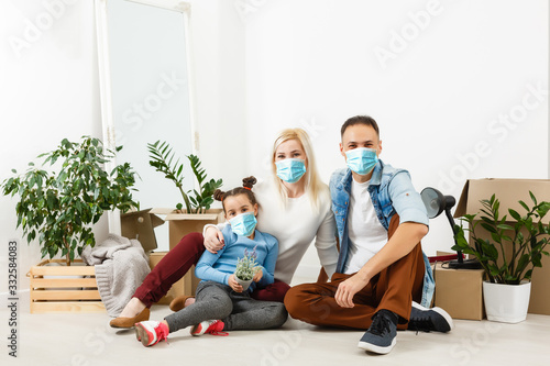 family in protective masks quarantined. Normal life with coronavirus. Lifestyle COVID-19. Quarantine virus protection sterility home together heart symbol