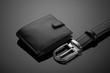 Fashionable leather men's wallet and belt on a black background