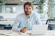© fotofabrika - Businessman in shirt working on his laptop in an office. Open space office