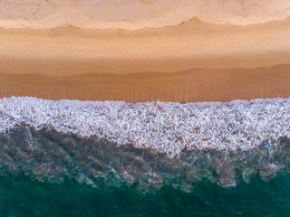  Beach aerial view of ocean water and sand shore.