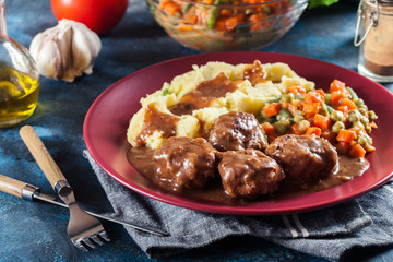 Wall Mural - Roasted meatballs in dark sauce with mashed potatoes