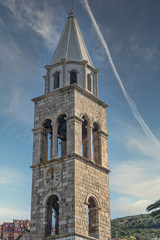 Wall Mural - A clock tower on an old stone tower in Dubrovnik, Croatia under blue sky