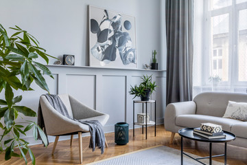 Wall Mural - Stylish scandinavian home interior of living room with design gray sofa, armchair, marble stool, black coffee table, modern paintings, decoration, plant and elegant personal accessories in home decor.