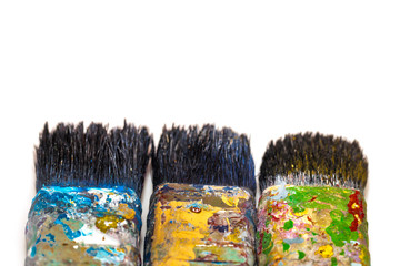 brushes in paints on a white background