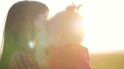 happy family, mother and child have fun outdoors in the park. the little lovely blonde girl is havin