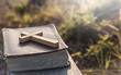© surachat - The Cross with old Bible lay on wooden plate, christian concept.
