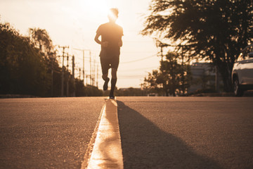 Wall Mural - Blurry subject Man running on road