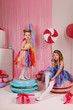 girls-models have fun at a birthday party in a beautiful, delicious, pink candy interior, the concept of themed children's parties, holidays, participation in competitions.