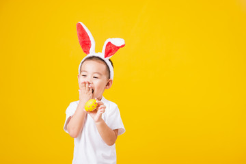 little children boy smile standing so happy bunny ears in Easter festival day holding easter eggs