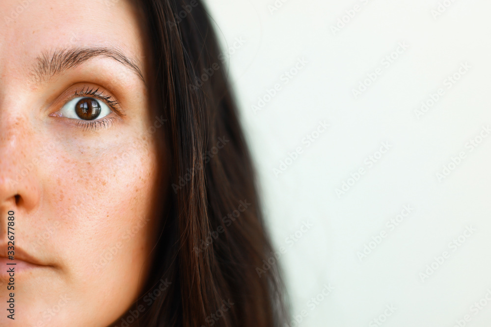 close up portrait of a woman half face - obrazy, fototapety, plakaty 