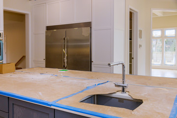 Kitchen contemporary with chrome fixture and white conter tops