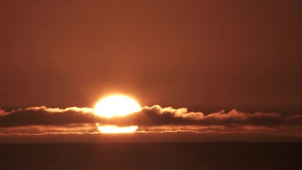 Wall Mural - Sunset Through Final Cloud Layer Time Lapse Over Sea