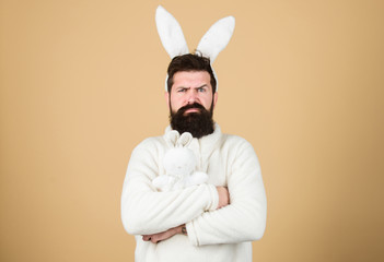 Wall Mural - Guy bearded hipster weird bunny with long white ears beige background. Easter rabbit. Man wearing rabbit suit. Funny bunny man soft ears. Easter activities concept. Weirdo concept. Celebrate Easter