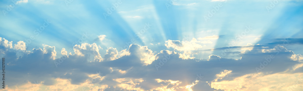 The background of sun rays over clouds. The sun rays break over the clouds. - obrazy, fototapety, plakaty 