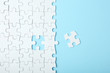 © White bear studio  - White puzzle on a colored background top view.