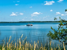 Beautiful Minnesota Lake Scene From The Shore Includes A Passing PoWooden Bird Watching Shelter Hut For Observing Wildlife In Port Aransas, Texas On A Sunny Day, Includes A Handicap Accessible Ramp.