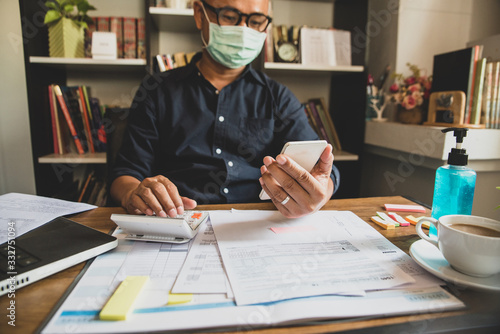 Fotografía Budget planning concept,Accountant wear mask is calculating company's annual tax
