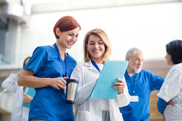 Group of doctors standing on medical conference, talking.