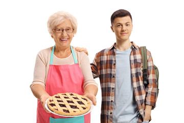 Sticker - Grandson standing next to his grandmother holding a pie