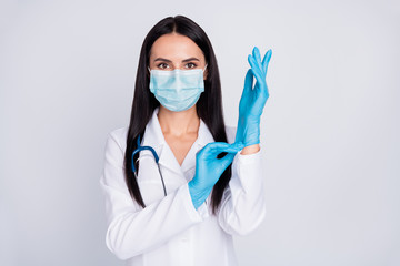 Canvas Print - Photo of beautiful doc lady ready for operation young professional surgeon taking on gloves wear protective mask stethoscope white lab coat isolated grey color background