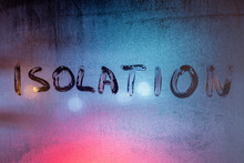 The Word Isolation Handwritten On Wet Window Glass At Night - Close-up Full Frame Picture With Selective Focus
