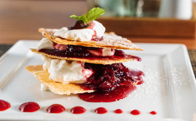 dessert with whipped cream and raspberries