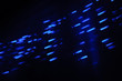 Movement of light. Concept of speed. Lines of blue stars or dots. Dark background.