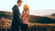 © Strelciuc - Caucasian charming couple sitting face to face and embracing during a sunny evening in a field