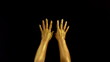 © Vit - Nice footage of woman gold hands gesture. Black background. Hands in gold color paint on black background.