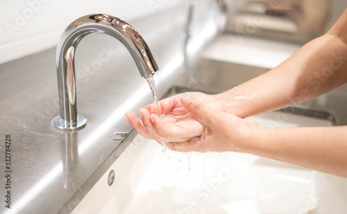 Fotografía Woman washing hand with soap and running water for coronavirus protection,