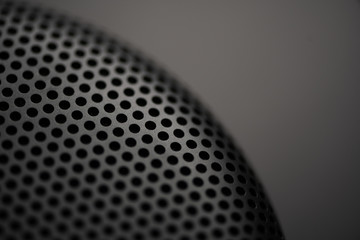 Black metal texture with round holes. Industrial background.