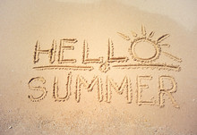 Handwritten Text Hello Summer. Golden Sand On Tropical Beach Near Sea Surf, Top View. Background For Travel And Vacation