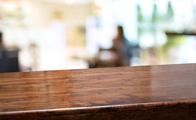 Leinwandbilder - Wood diagonal table with people dinner at restaurant blur background.Empty perspective hardwood bar with blur coffee shop with bokeh light,Mock up  banner for display of product
