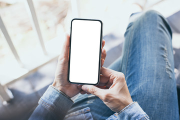 Mockup image blank white screen cell phone.woman hand holding texting using mobile sitting at coffee shop.background empty space for advertise text.people contact marketing business,technology