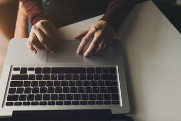 Hand business working using laptop  communication network,Interior home office blurred background.