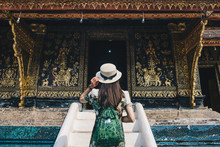 Back View Of Woman Tourist Visiting Wat Xieng Thong An Iconic Temple In Luang Prabang, The UNESCO World Heritage Town In North Central Of Laos. Conceptual Of Tourist Enjoying Vacation And Holiday.