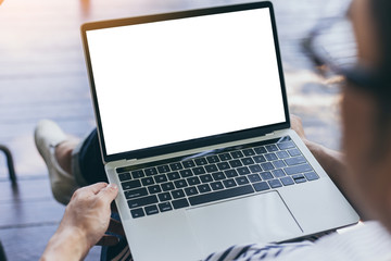 mockup image blank screen computer with white background for advertising text,hand man using laptop contact business search information on desk at coffee shop.marketing and creative design