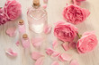© OlgaKot20 - Rose water or oil in glass bottles with pink fresh rose flowers and petals on wooden background, SPA concept and aromatherapy