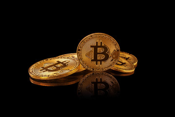 Bitcoin. Crypto currency Gold Bitcoin, BTC, Bit Coin. Bitcoin mining concept. Several bitcoin gold coins isolated on black background with reflection