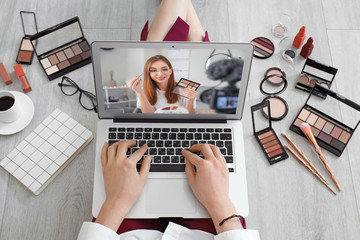 Canvas Print - Female makeup artist with laptop at home