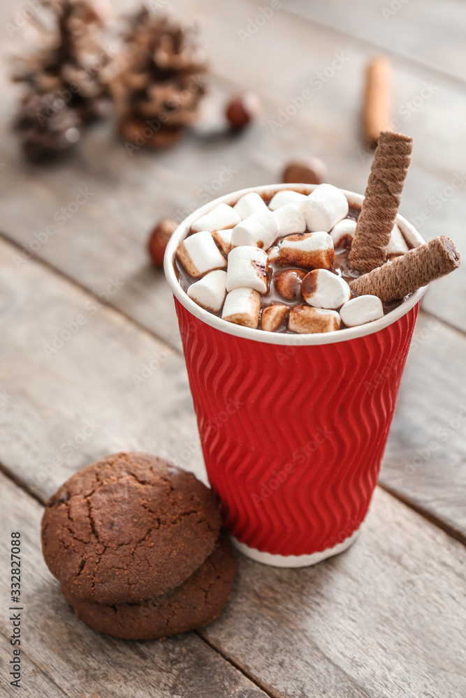 Cup of hot chocolate with cookies on table
