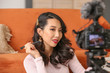 © Pixel-Shot - Female Asian beauty blogger recording video at home