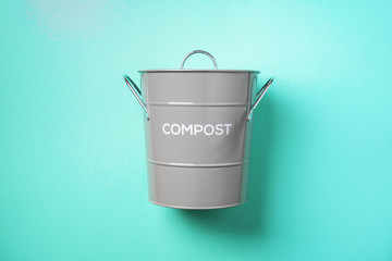 Wall Mural - Recycling food waste bin for compost on blue background. Top view. Copy space. Sustainable and zero waste living.