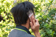 © Onkamon - Men use plastic bag to cover mobile phone to prevent the covid-19 virus.