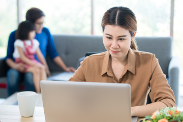 Businesswoman working from home in bedroom